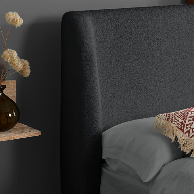 close up on grey boucle headboard of evelyn bed