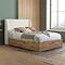 oak ottoman bedframe with white boucle headboard, dressed in sheets and decorated with natural coloured cushions and throws