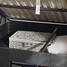 close up image inside ottoman compartment space of dark grey fabric bed