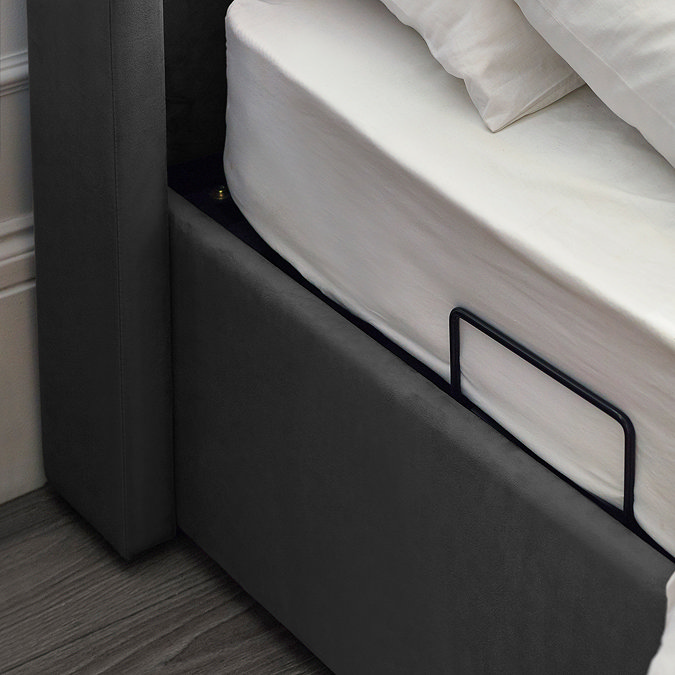 close up image of dark grey base of ottoman bed, with lift handles
