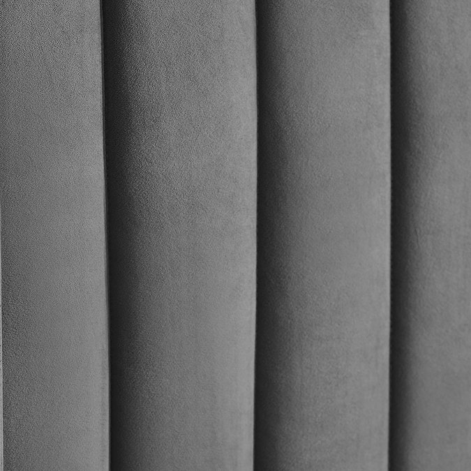 close up image of dark grey panelled headboard