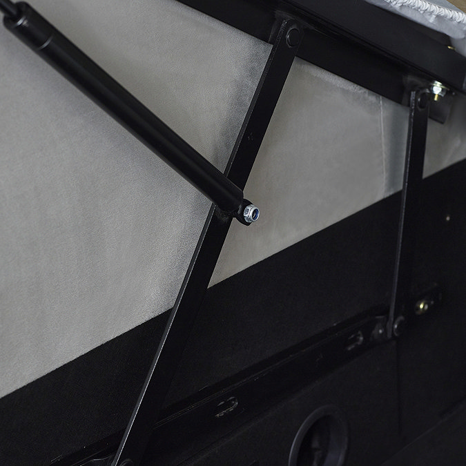 close up image of black metal side lifts of storage compartment in light grey ottoman bed