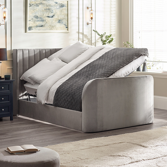 image of light grey fabric ottoman bed, lifted up on one side to suggest storage space