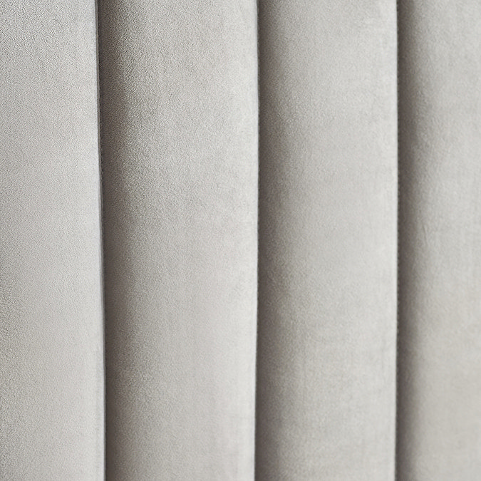 close up swatch image of light grey velvet fabric of ottoman bed
