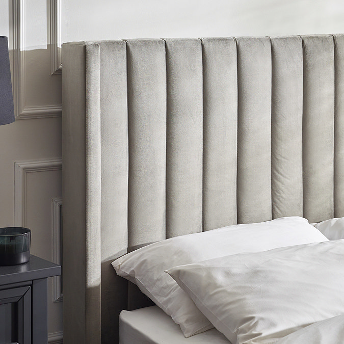 close up image of velvet light grey headboard of ottoman bed