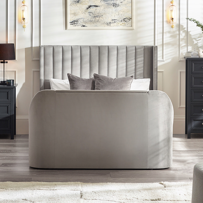 front on image of light grey fabric ottoman bed with rounded footboard and panelled headboard
