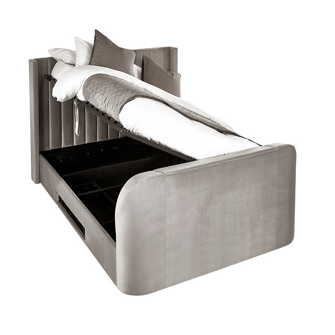image cut out on white background of light grey fabric ottoman bed, with side lifted up to show storage space within
