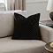 45x45cm square black cushion with geometric detailing, sat in a corner of cream sofa
