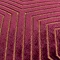 close up on texture of burgundy cushion with gold geometric detailing. 