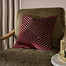 45x45cm burgundy red cushion with geometric detail, sat on dark khaki chair