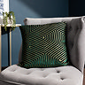 45x45cm emerald green cushion with geometric detailing, sat on grey chair