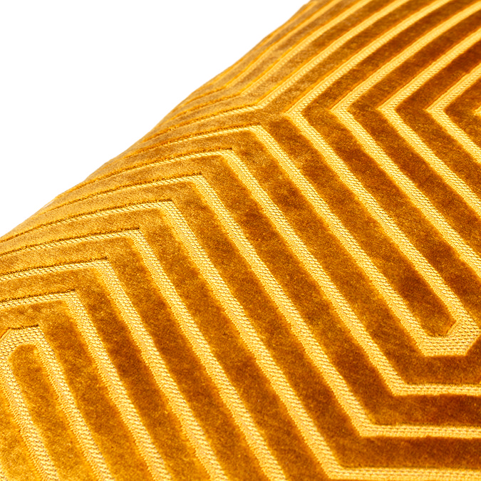 close up image of gold velvet cushion, highlighting texture and design