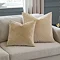 two sizes of ivory velvet cushion, 45x45 and 55x55cm, next to each other on a cream sofa.