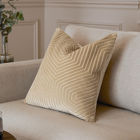 45x45cm ivory cushion with geometric detailing, sat in corner of cream sofa