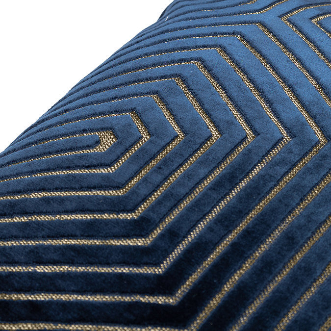 close up on pattern of navy blue velvet cushion with gold geometric detail