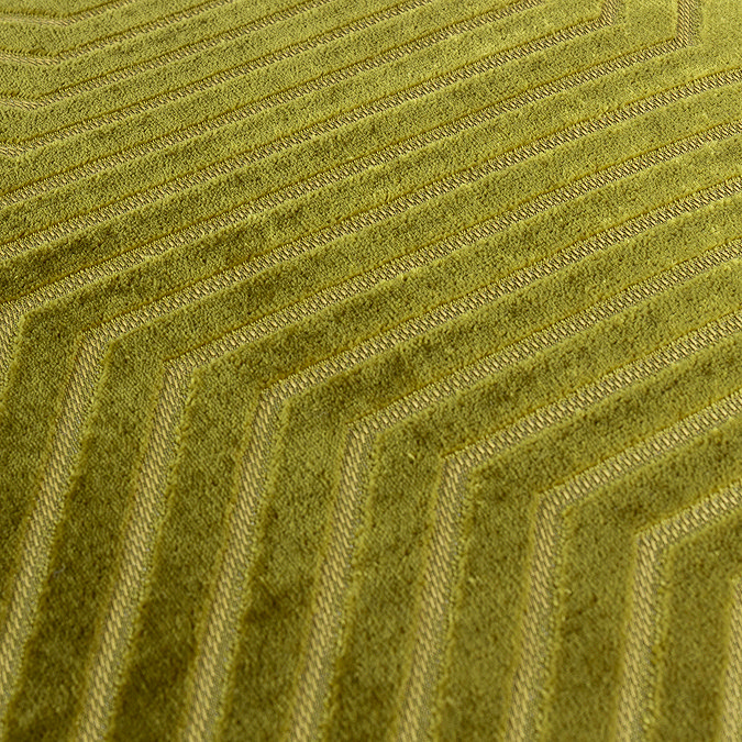 close up on pattern of olive green velvet cushion with geometric detailing