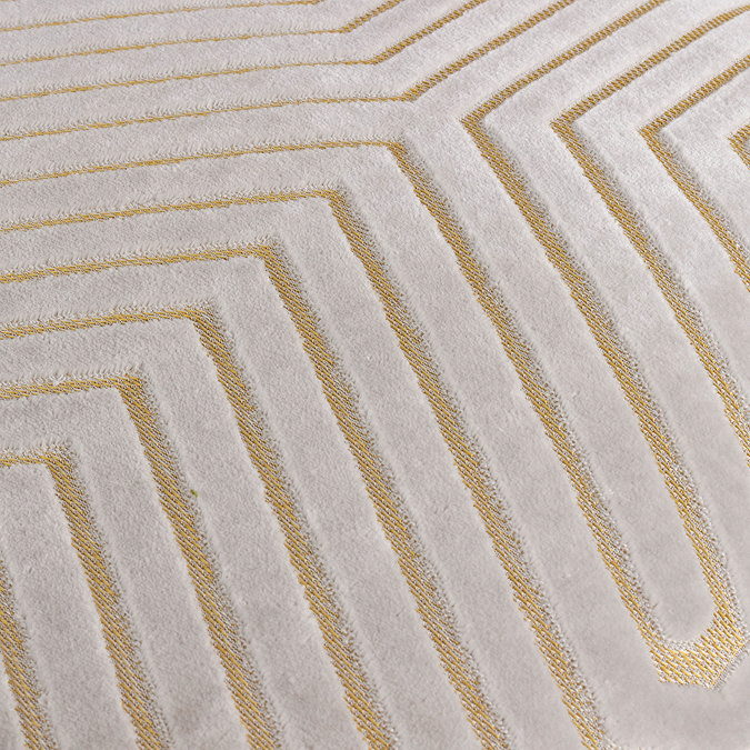 close up of pattern of oyster coloured velvet cushion with geometric cut detailing
