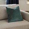 45x45cm teal cushion with geometric detailing, sat in corner of cream sofa