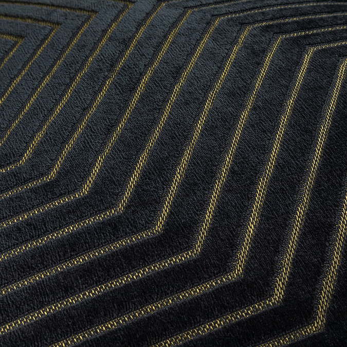close up on pattern of black velvet cushion with gold geometric detail