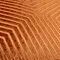 close up of pattern on brick orange cushion with gold geometric cut detail