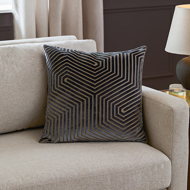 charcoal grey square cushion with geometric detailing, cut out on white background