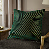 emerald green square cushion with geometric detailing, sat on khaki chair