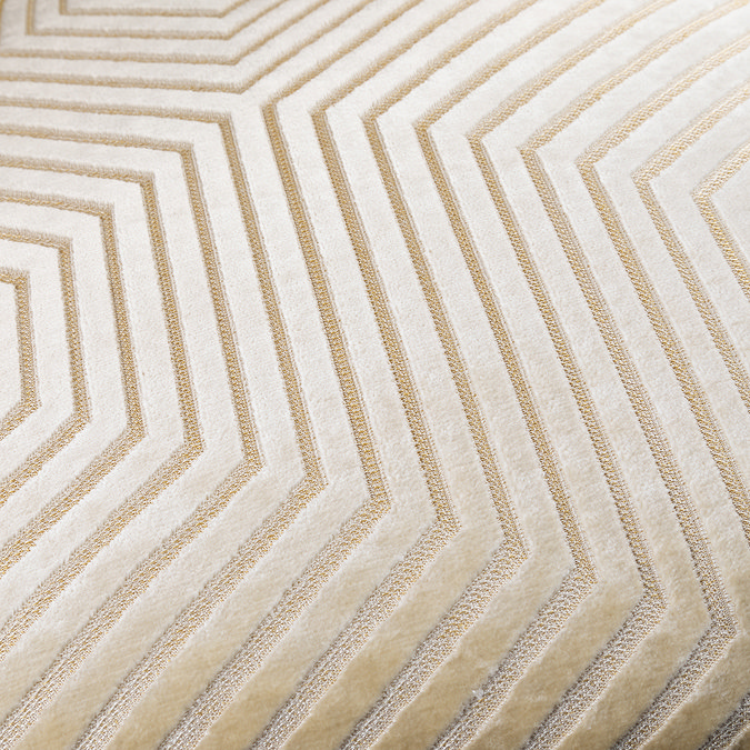 close up on pattern of ivory velvet with gold geometric stitching
