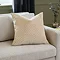 ivory square cushion with geometric detailing sat on cream sofa