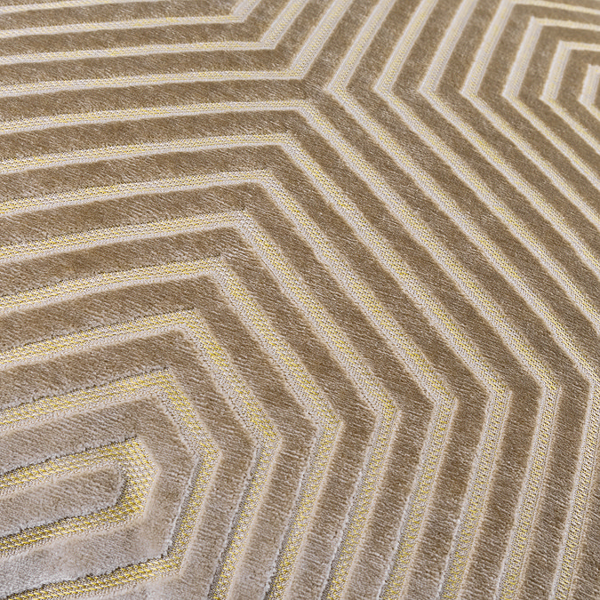 close up on light brown velvet cushion with geometric pattern