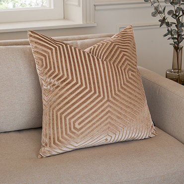 mink coloured square cushion with geometric detailing, cut out on white background