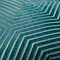 close up on pattern of teal green cushion with gold geometric stitch detail
