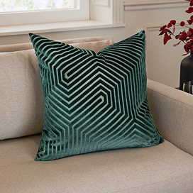 55x55cm teal green cushion with geometric detailing, sat in corner of cream sofa