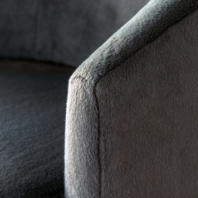 close up on grey fabric on arm of deep curved accent chair