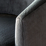 close up on grey fabric on arm of deep curved accent chair