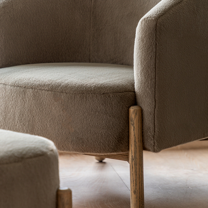 close up on ash wood leg of soft khaki accent chair