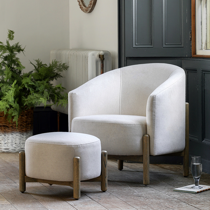 wide image of natural coloured fabric accent chair with matching stool