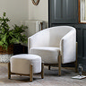wide image of natural coloured fabric accent chair with matching stool