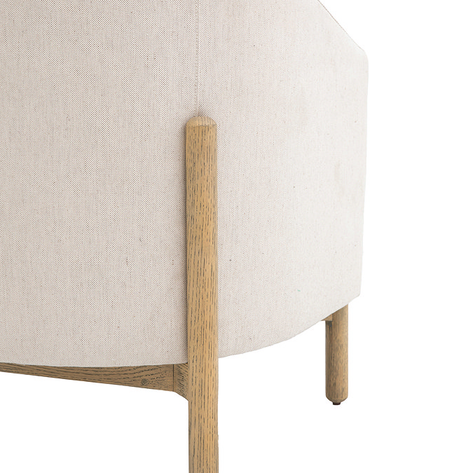 close up image of oak wood legs on natural coloured fabric accent chair