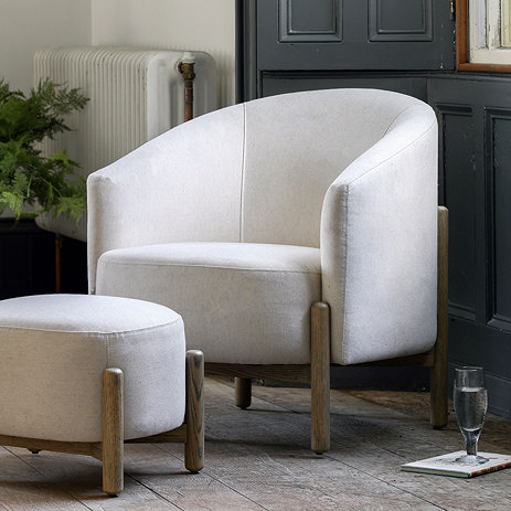 image of natural coloured fabric armchair with oak wood legs
