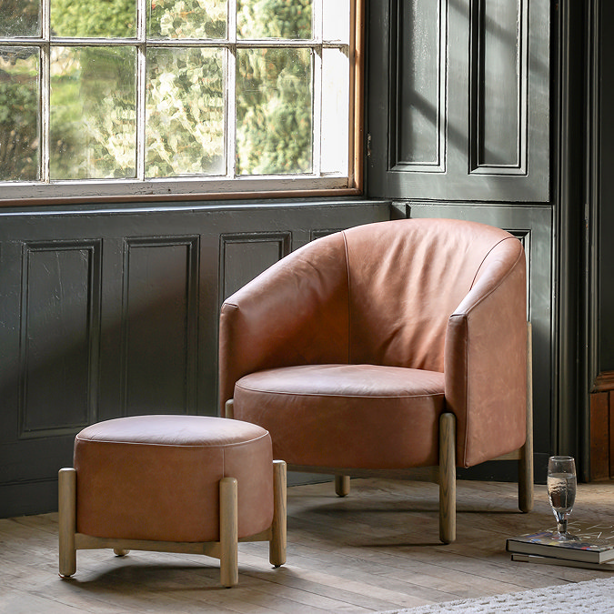 wide image of vintage brown leather accent chair with matching footstool