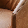 close up image on vintage brown leather material of accent chair