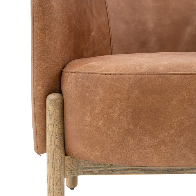 close up image of seat depth of vintage brown leather accent chair