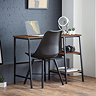 walnut coloured desk with black metal framework and modern grey chair pushed underneath
