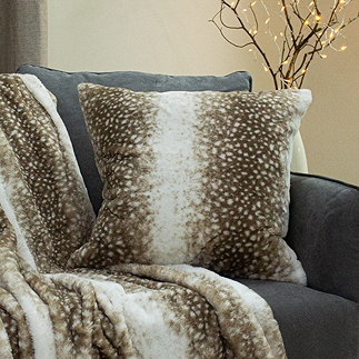 fawn faux fur cushion on a sofa