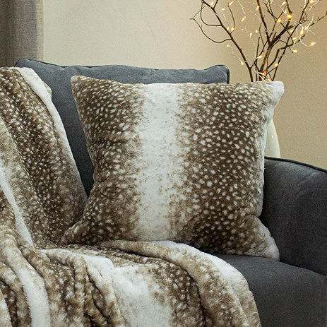 fawn faux fur cushion on a sofa