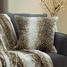 fawn faux fur cushion on a sofa