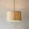 image of natural woven seagrass pendant light with black fixture hanging from a ceiling