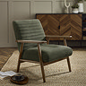 image of dark olive green chenille accent chair with warm brown arms and legs on a jute rug in a living room