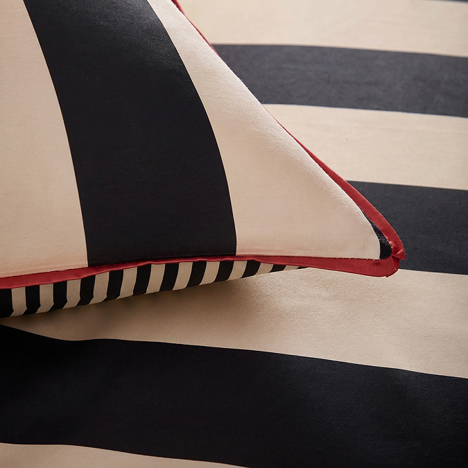 close up image of cream and black striped bedding