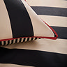 close up image of cream and black striped bedding